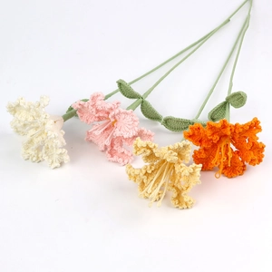 Macro detail of handmade crochet lily flowers in white, pink, yellow and orange tones