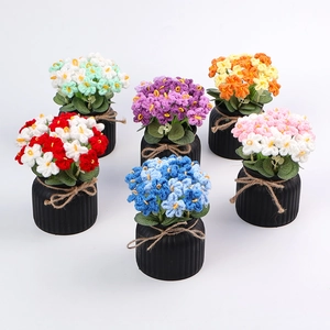 Detail of six colorful handmade crochet flower pots with rustic jute bow decorations