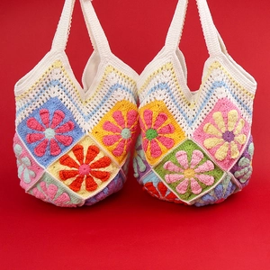 Handmade crochet floral tote bag with colorful granny square patterns for summer beach vacation