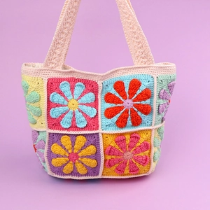 Handmade crochet granny square tote bag with colorful daisy floral pattern design