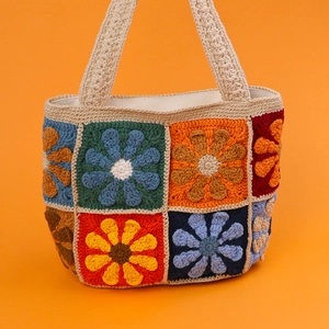 Handmade crochet daisy pattern shoulder bag with colorful knitted flower patches