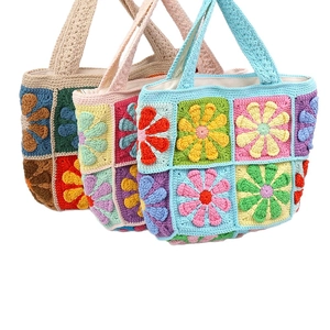 Handmade crochet daisy shoulder bag with multi-colored floral patchwork and knit texture