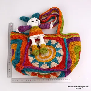 Macro view of handmade crochet tote bag featuring mandala flower pattern and bunny charm