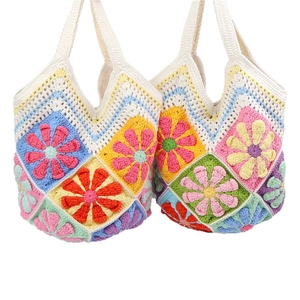 Handmade bohemian crochet tote bag featuring vibrant floral patterns and colorful knit textures