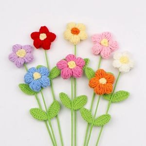 Dettaglio di fiori puff realizzati all'uncinetto a mano in otto colori con foglie verdi