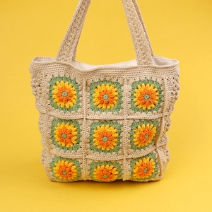 Handmade crochet sunflower tote bag featuring 3x3 floral patterns and beige knit straps