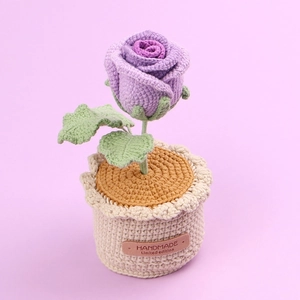 Handmade crochet purple rose in a cream knitted pot with handmade leather label