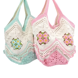Handmade crochet daisy flower tote bags in light blue and pink with woven mesh pattern