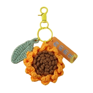 Handmade crochet sunflower keychain with green leaf and yellow metal lobster clasp on white