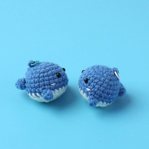 Handmade crochet whale keychains in blue and white yarn for bags and accessories