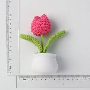 Handmade crochet pink tulip plant in white pot with measuring rulers showing 12.5cm height