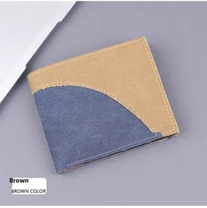 Detail of bifold canvas wallet featuring contrast stitching and khaki blue color blocking