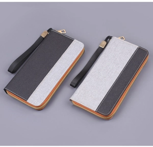Detail of canvas clutch bags with stitching and gold metal zipper hardware