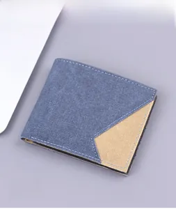 Detail of blue canvas bifold wallet with khaki stitching and textured fabric finish