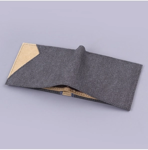 Detail view of denim canvas wallet showing contrast stitching and inner card slots