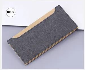 Close-up of charcoal canvas long wallet with khaki trim and fine stitching details