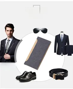 Detail of grey-blue canvas and brown leather long wallet for men with sleek fashion suit