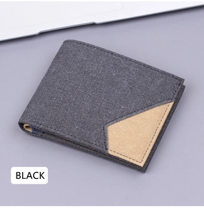 Detail of bifold canvas wallet with stitching and brown decorative patch accent