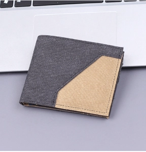 Detailed view of men's canvas bifold wallet with grey and khaki diagonal color blocking
