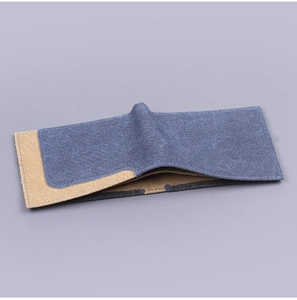 Detail of bifold canvas wallet with durable denim fabric and vintage contrast stitching