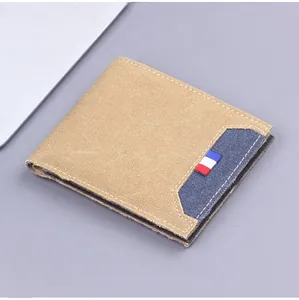 Detail of khaki canvas men's wallet featuring blue pocket and red white blue ribbon tag