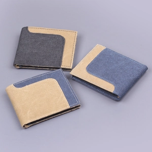 Three slim canvas bi-fold wallets for men in assorted patchwork colors on grey background