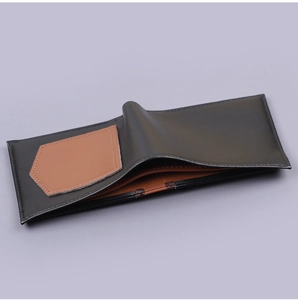 Detail view of bi-fold wallet featuring contrasting inner card slots and precision stitching