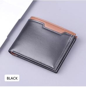 Close-up of minimalist bi-fold men's wallet in matte black leather with brown edge detail