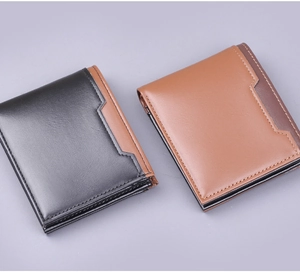 Detail view of black and brown leather bifold wallets with geometric patchwork and stitching