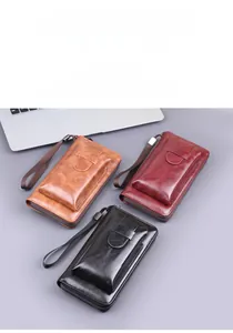 Three vintage style faux leather wristlet wallets in brown, red, and black with card slots