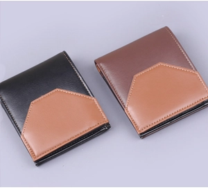 Detail view of two-tone men's bifold wallets in black and brown textured leather
