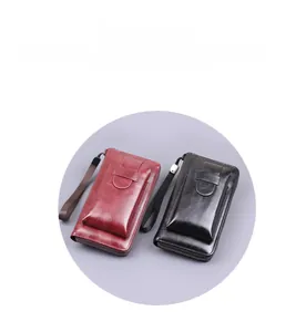 Detail view of burgundy and black vintage leather clutch wallets with wrist straps
