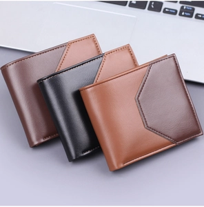 Three-fold leather wallets in black and brown arranged on an office desk setting