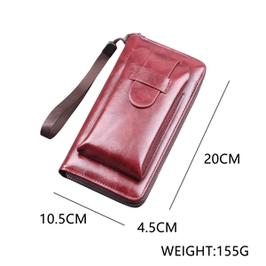 Reddish-brown long zipper clutch bag with wrist strap and textured leather finish