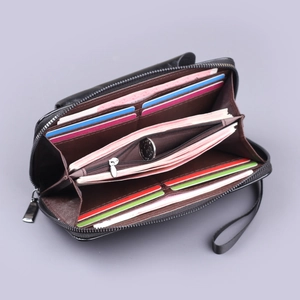 Elegant black leather zip wallet with brown interior featuring multiple card slots and wrist strap