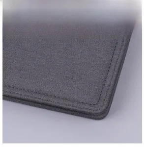 Detail shot of reinforced double-stitched corners on gray canvas wallet for men