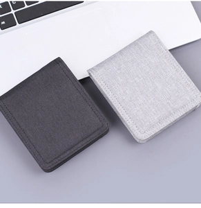 Detail of slim canvas bifold wallets in light and dark grey with textured fabric finish