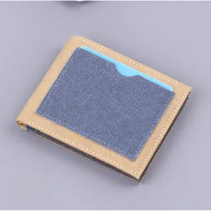 Detail of khaki canvas men's bifold wallet with dark blue denim exterior card slot and stitching