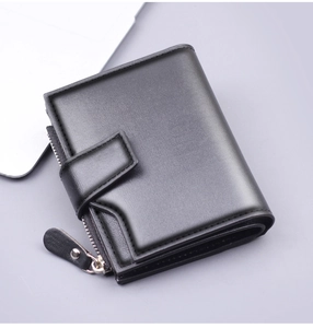 Detailed view of men's black tri-fold wallet with secure zipper pocket and metal snap button