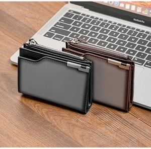 Vertical slim leather wallet with silver zipper and L-shaped metal trim on wooden desk