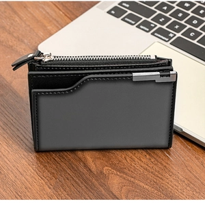Men's vertical short wallet with multiple card slots and zipper on a wooden desk