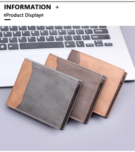 Close-up of slim men's bifold wallets with orange stitching on a laptop keyboard