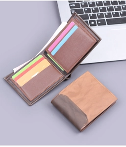 Detailed view of bi-fold men's wallet in brown and coffee faux leather with card slots