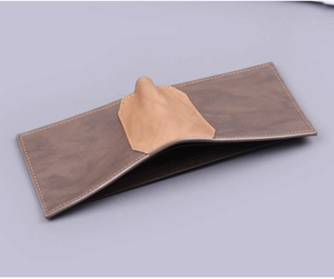 Detail of short leather wallet for men featuring a unique 3D nose design and fine stitching