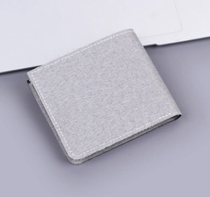 Detail view of light grey canvas bifold wallet with contrast white stitching details