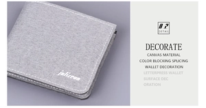 Close-up of grey canvas men's wallet featuring woven texture and white contrast stitching