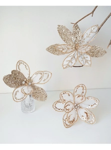 Detailed view of champagne mesh Christmas flowers with sequins and pearl centers