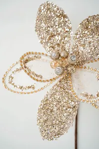 Macro view of champagne gold mesh Christmas flower with sequins and central gemstone