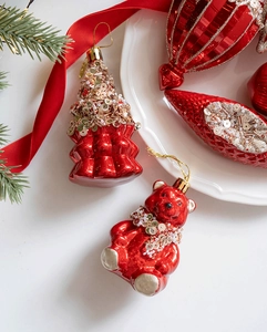 Detail of red bear and tree Christmas ornaments with sequins and golden hanging strings