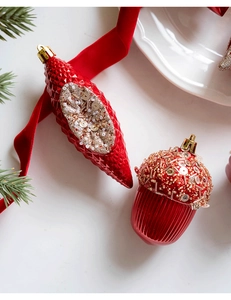 Detailed view of red Christmas acorn and spindle ornaments with gold sequins and beads